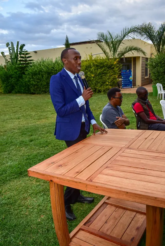 Simon Mugetha speaking to students outdoors