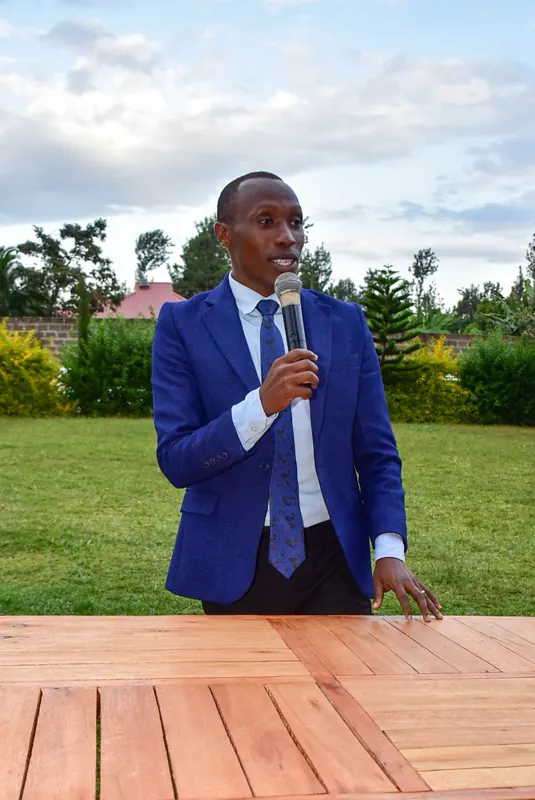 Simon Mugetha speaking to students outdoors