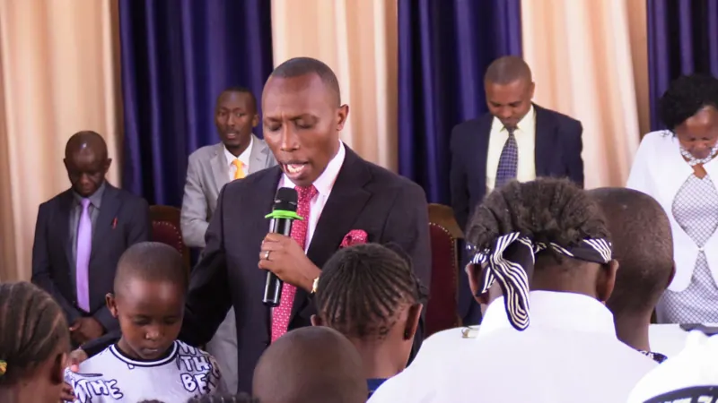Simon Mugetha speaking at a church service