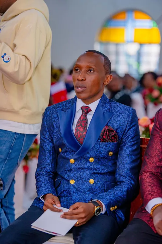 Simon Mugetha seated at a church wedding