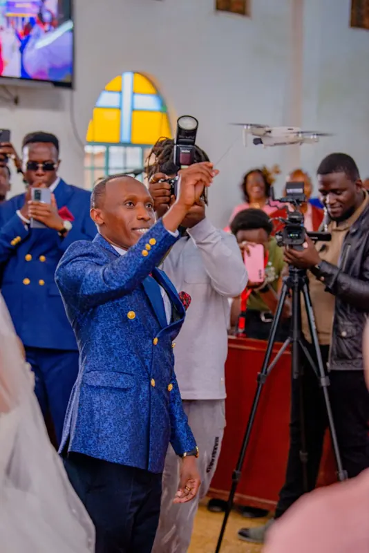 Simon Mugetha among photographers at a wedding