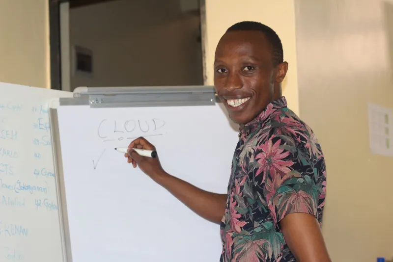 Simon Mugetha at a whiteboard during a cloud session